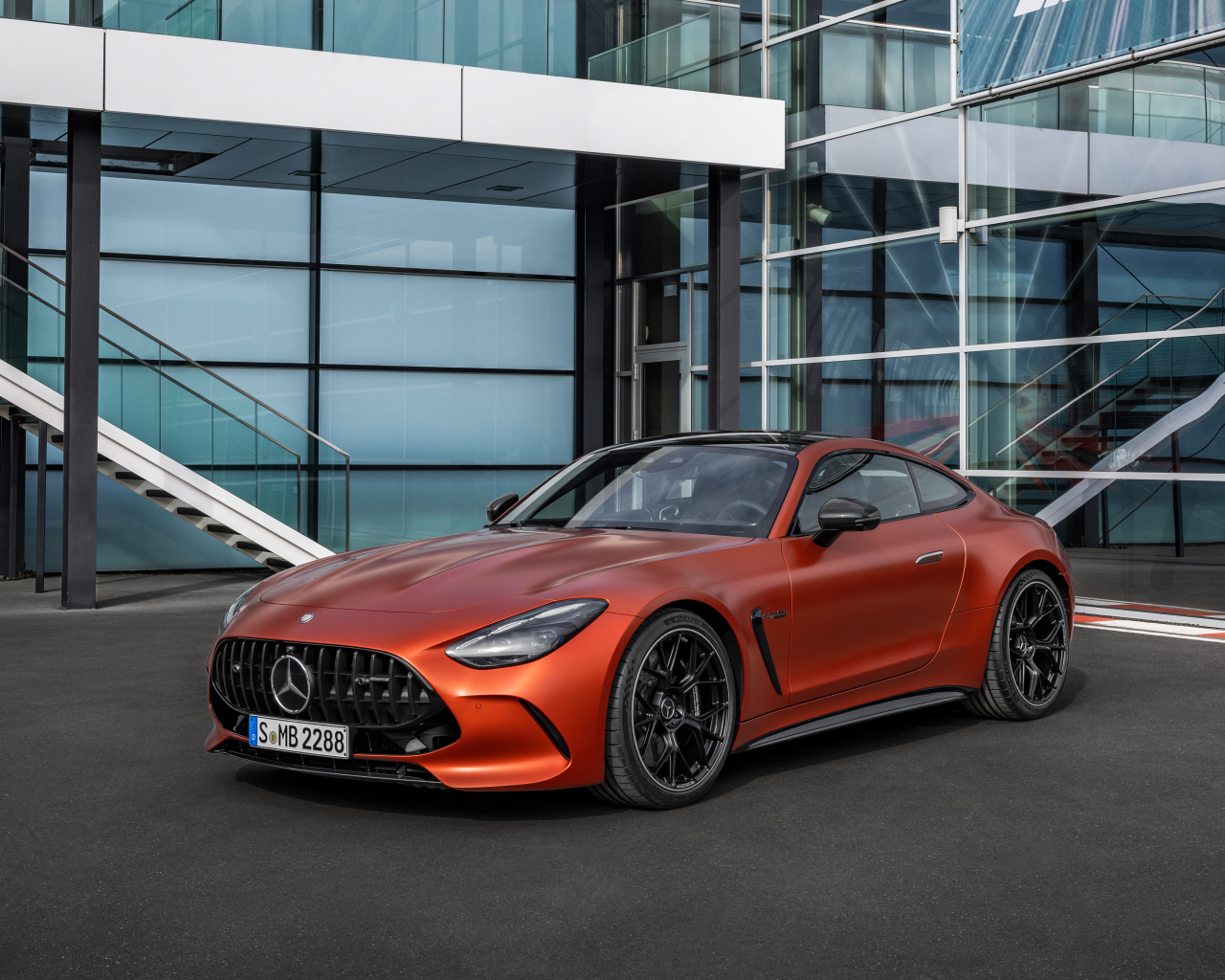 Красный автомобиль Mercedes-AMG GT 63 S E Performance 2024 года у здания