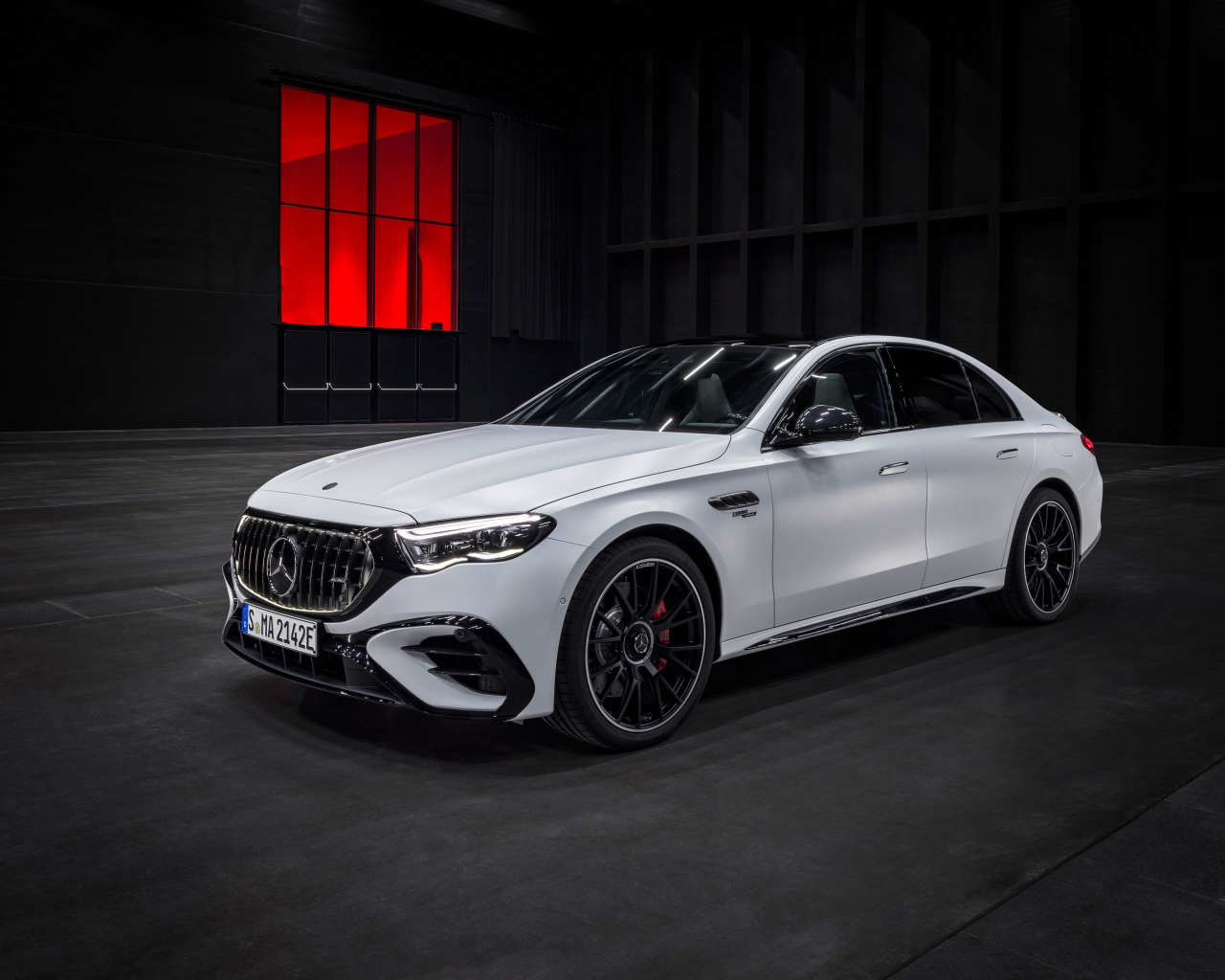 Белый автомобиль Mercedes-AMG E 53 HYBRID 4MATIC+ 2024 года на черном фоне