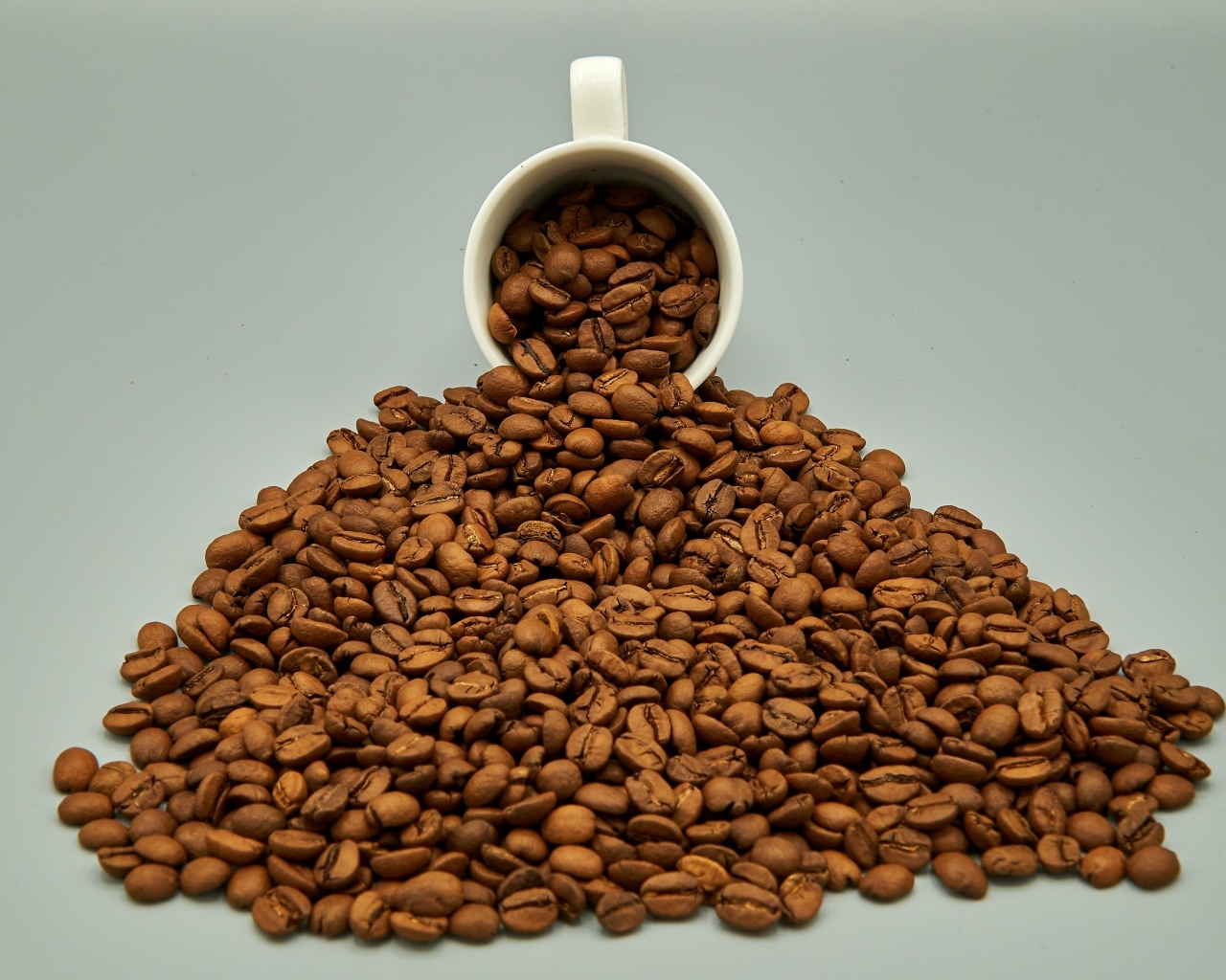 Чашка с горкой кофейных зерен