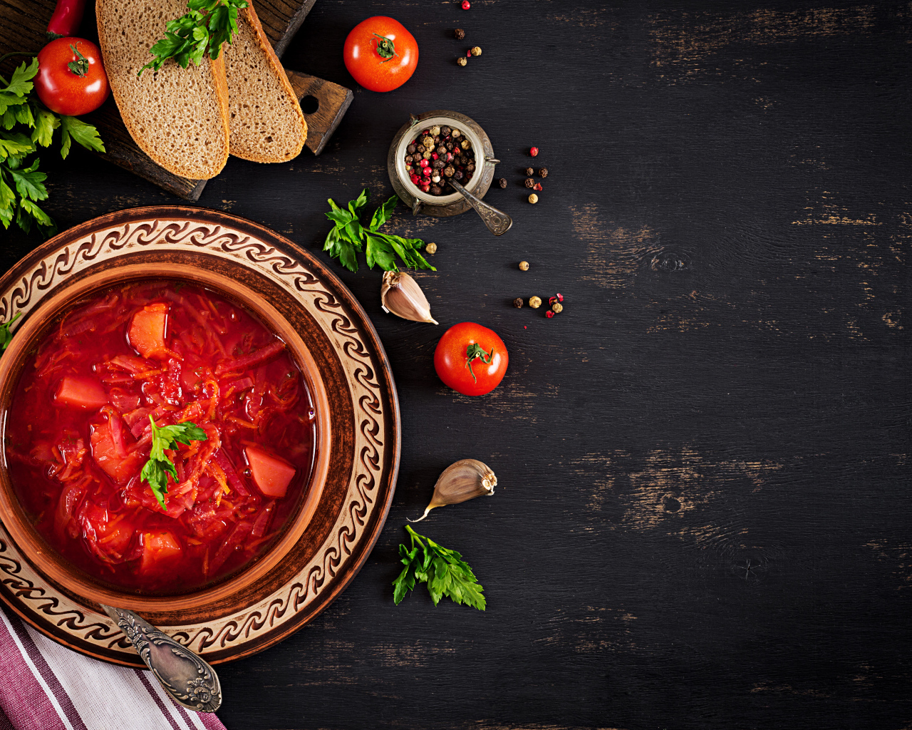 Вкусный красный борщ в тарелке на столе