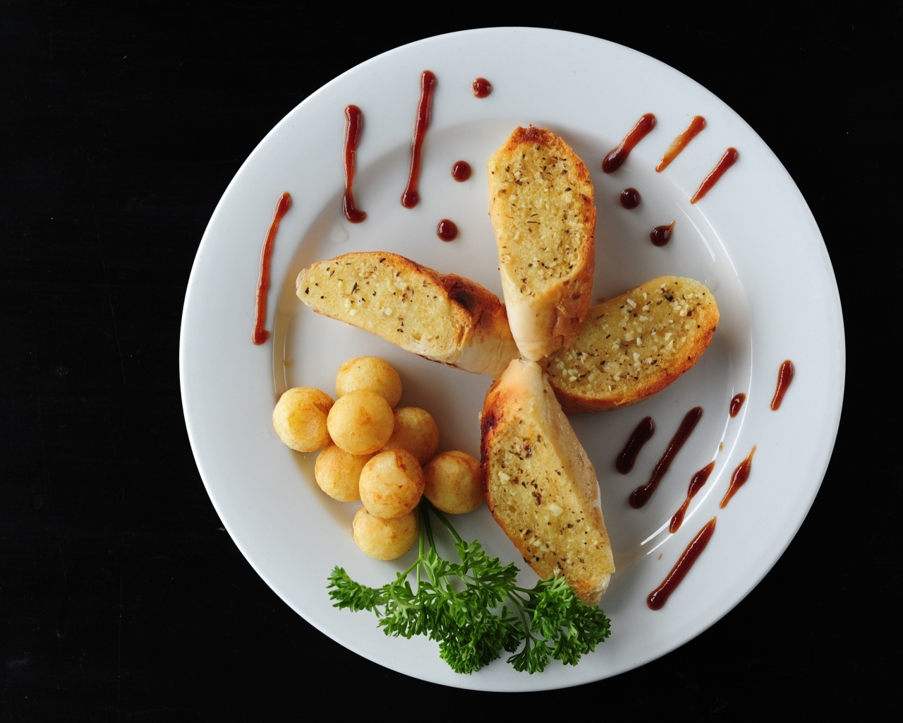 Чесночный хлеб на тарелке с картофельными шариками