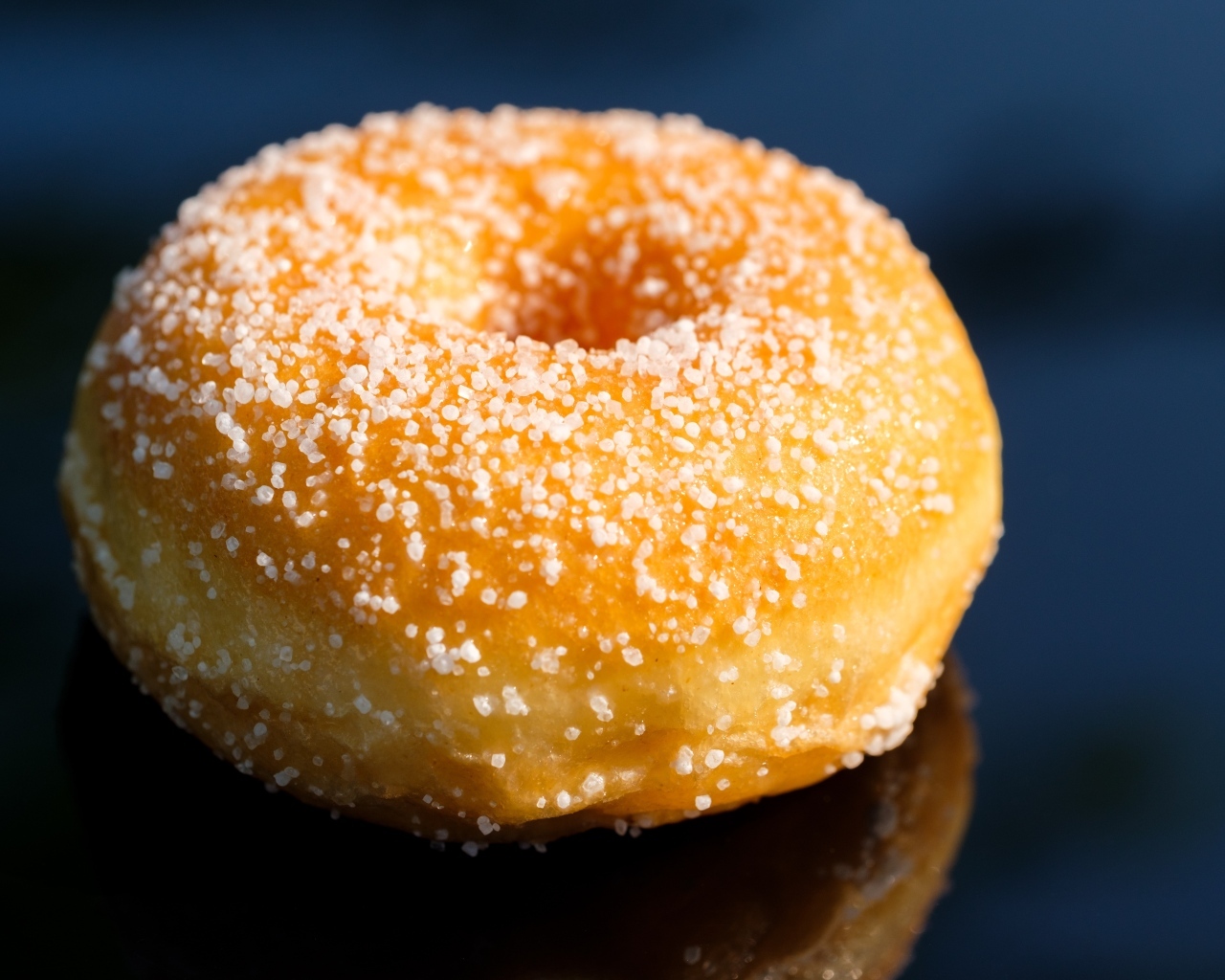 Аппетитный сладкий донат на сером фоне