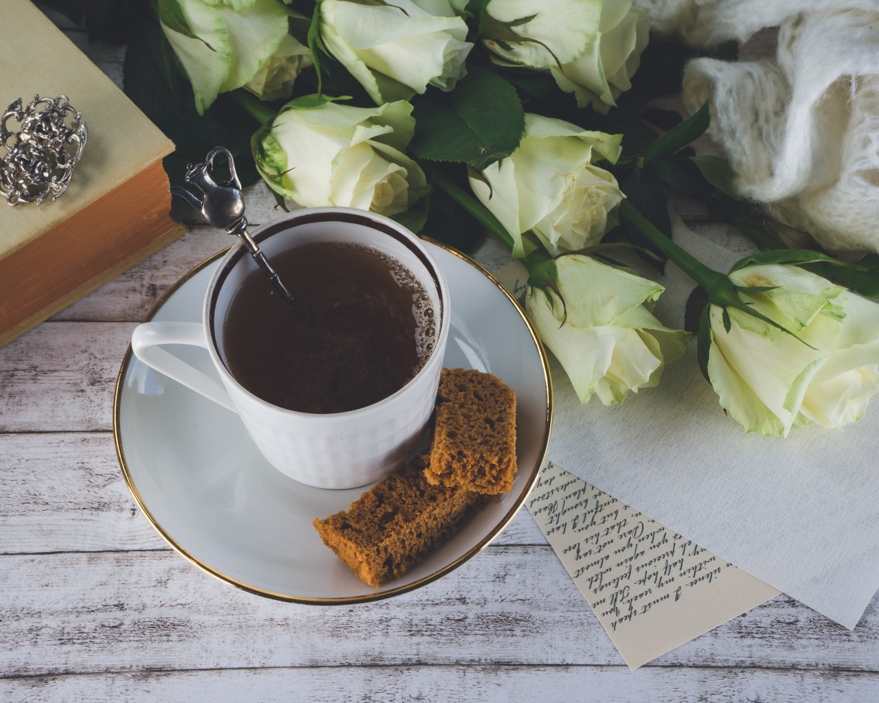 Чашка кофе на столе с букетом белых роз