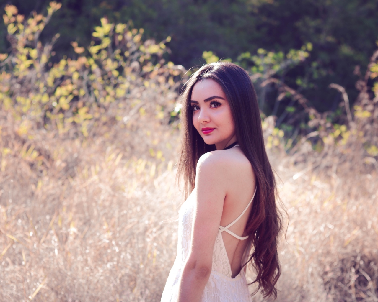 Милая длинноволосая девушка на поле 