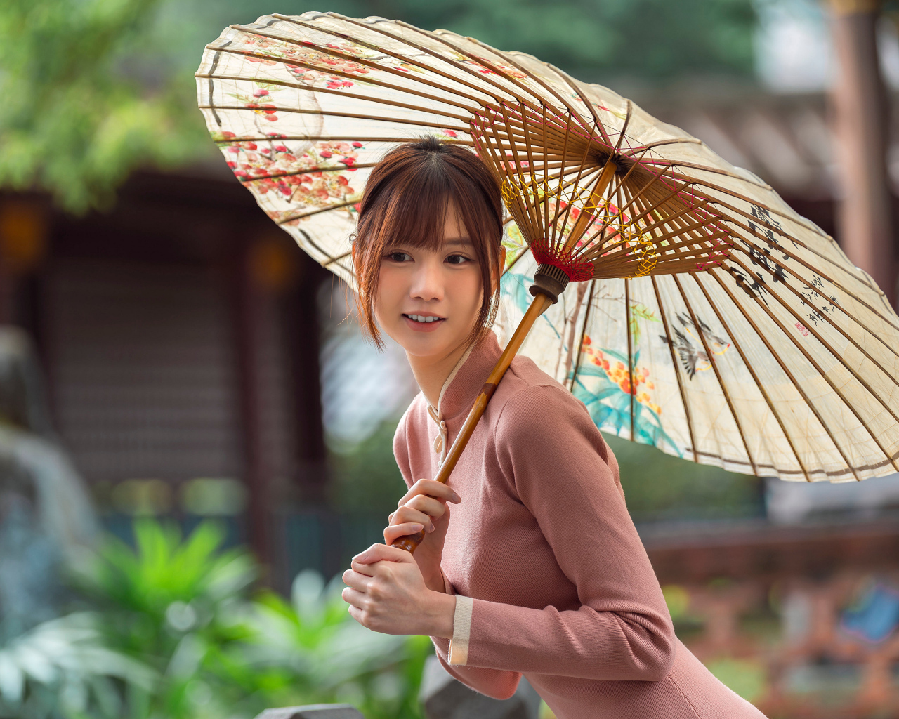 Милая улыбающаяся азиатка с зонтом