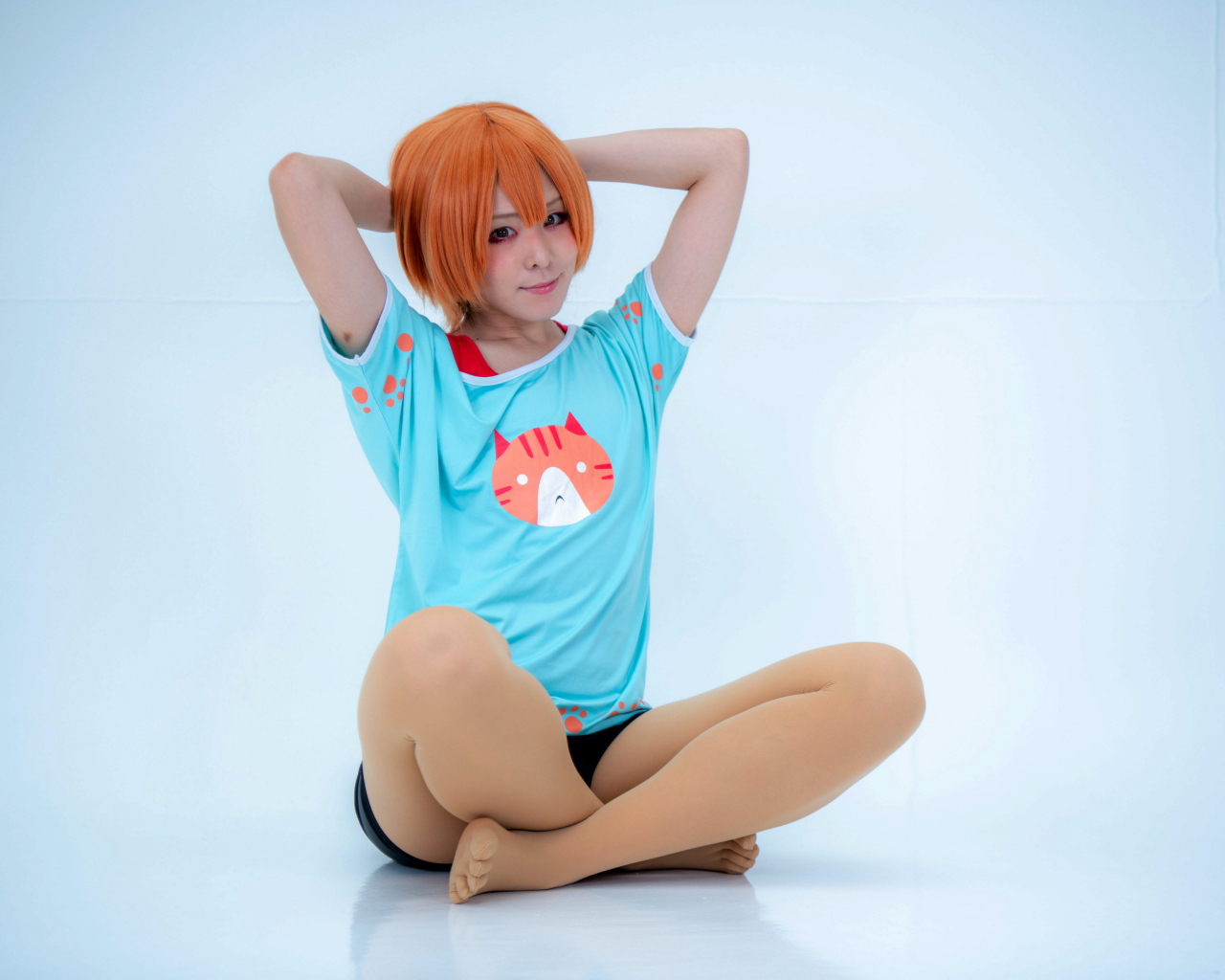 Рыжеволосая азиатка в милой футболке на голубом фоне