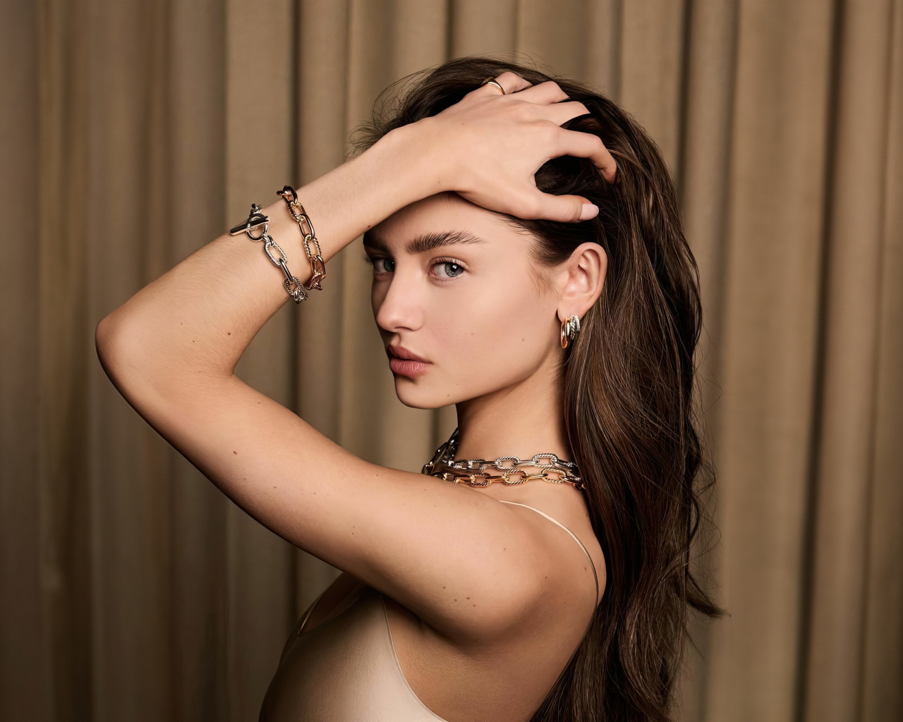 Модель Лени Олуми Клум  с руками в волосах