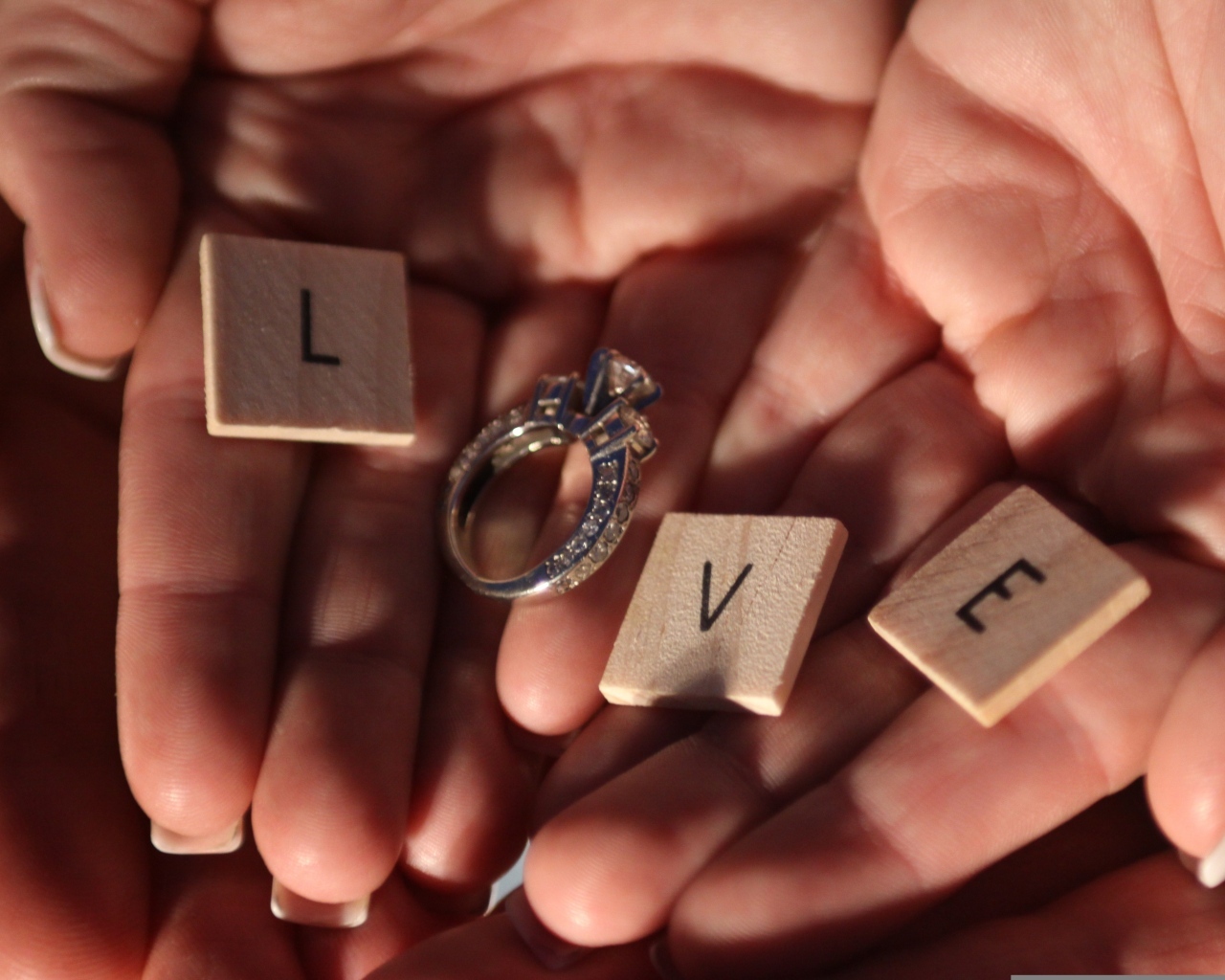 Кубики и кольцо на ладонях с надписью любовь