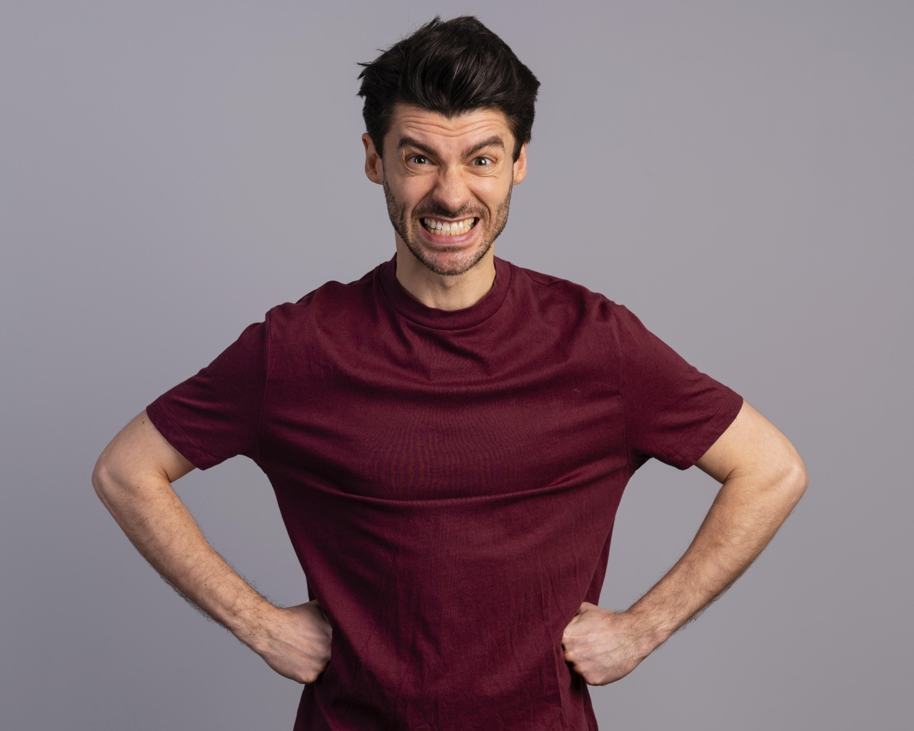 Злой мужчина на сером фоне