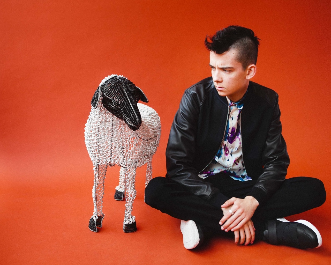 Молодой актер Эйса Баттерфилд на красном фоне