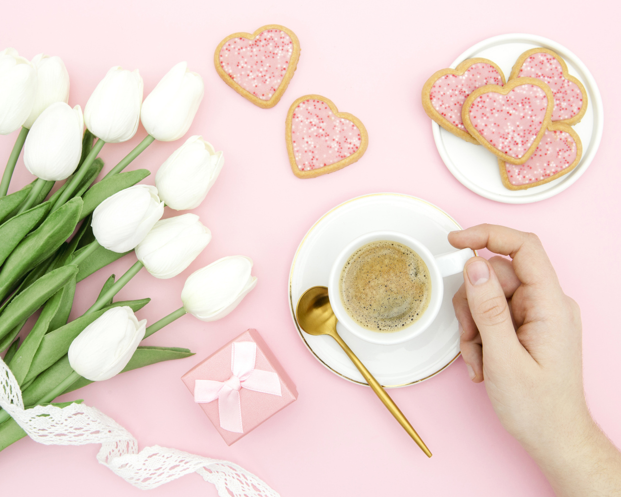 Bouquet of white tulips with a cup of coffee and cookies for your beloved