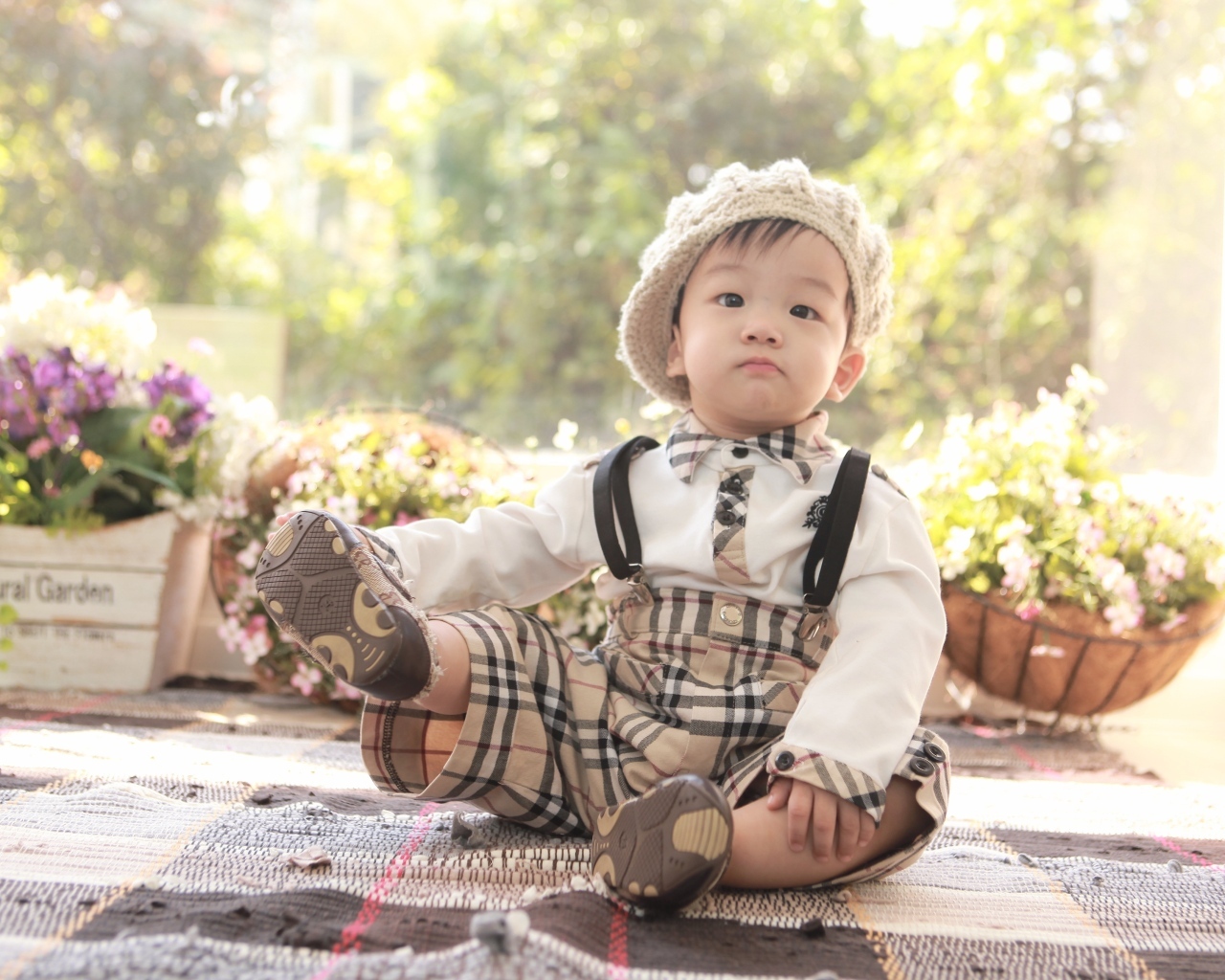 Смешной мальчик азиат у цветов