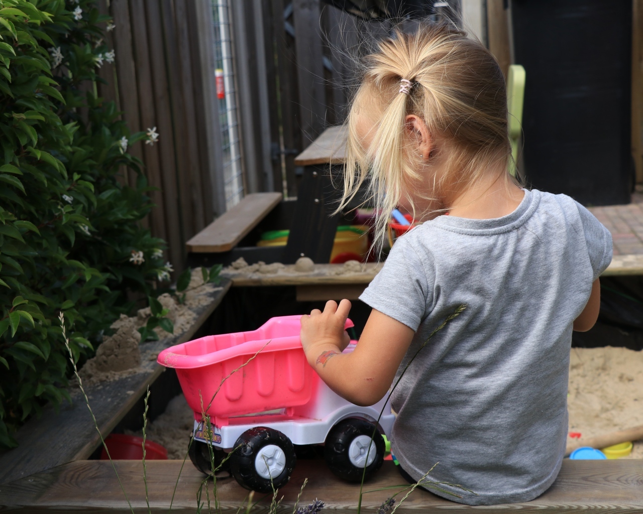 Девочка играет с игрушечной машинкой