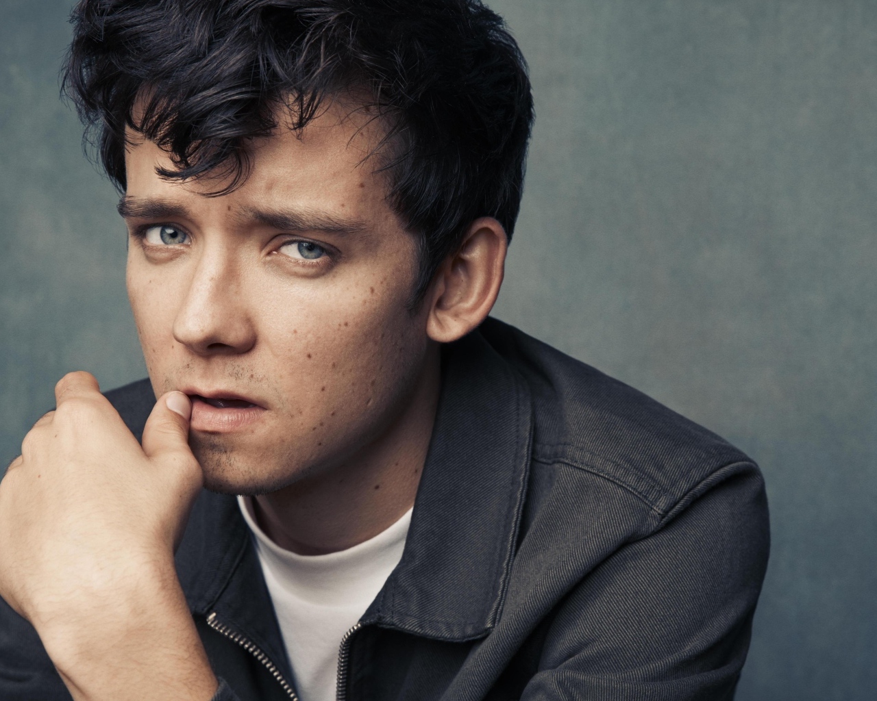 Актер Эйса Баттерфилд на сером фоне