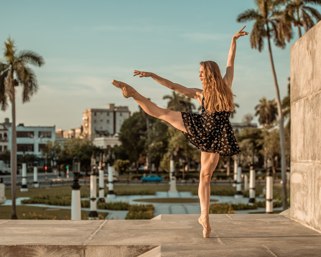 Балерина в лучах солнца у стены