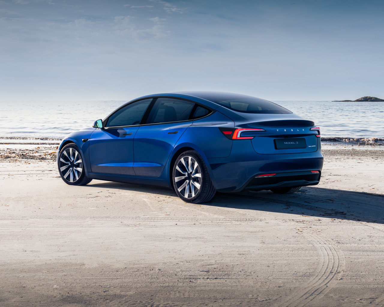 Синий автомобиль Tesla Model 3 2024  года вид сзади