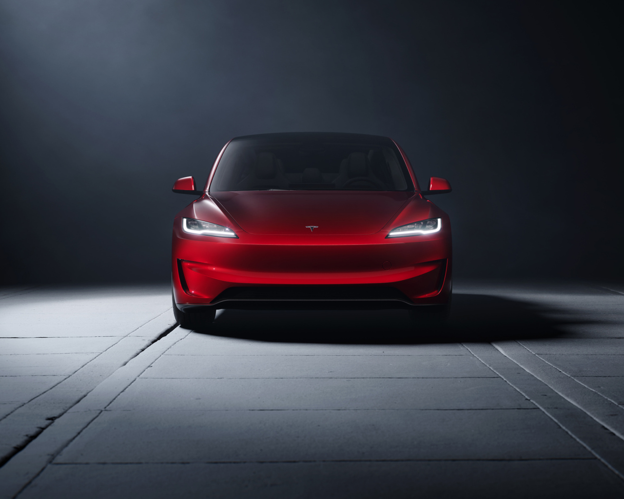 Вид спереди на красный автомобиль Tesla Model 3 Performance 2024 года