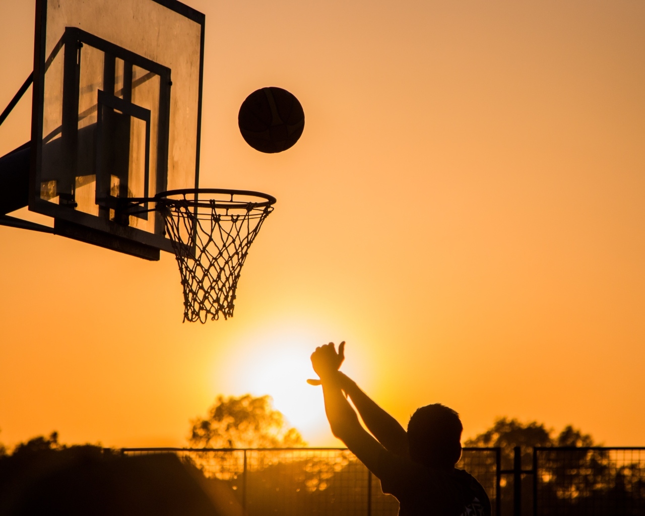 Бросок в баскетбольное кольцо на закате