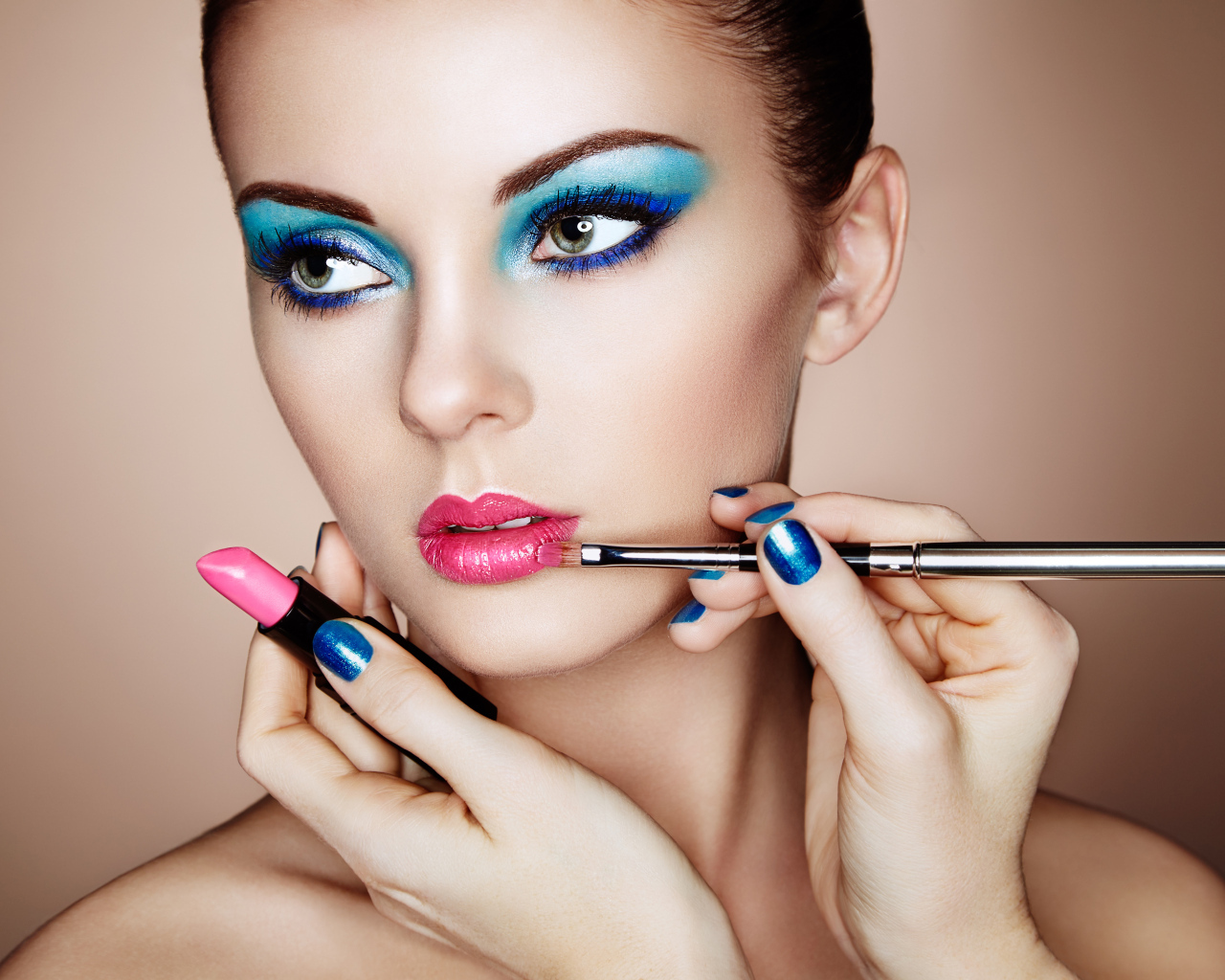 Девушке делают красивый яркий макияж