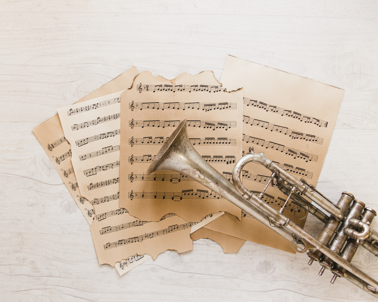 Trumpet and old sheet music on the table