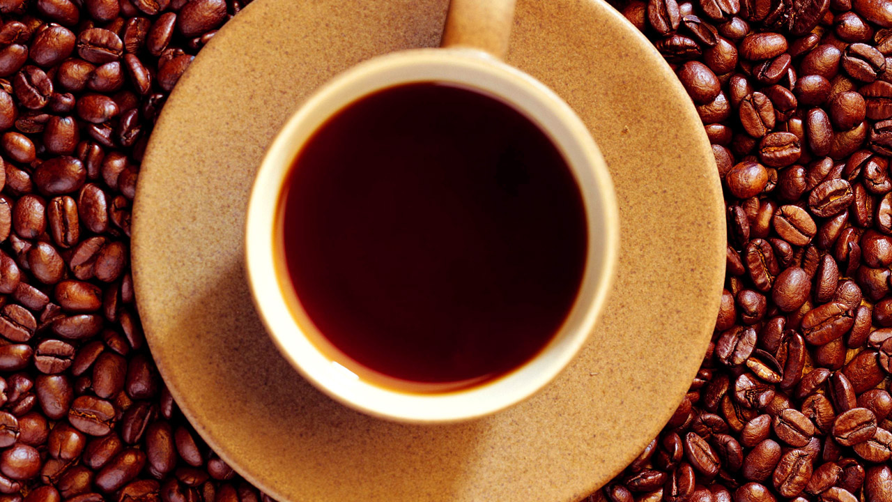 Кофейные зерна и чашка кофе