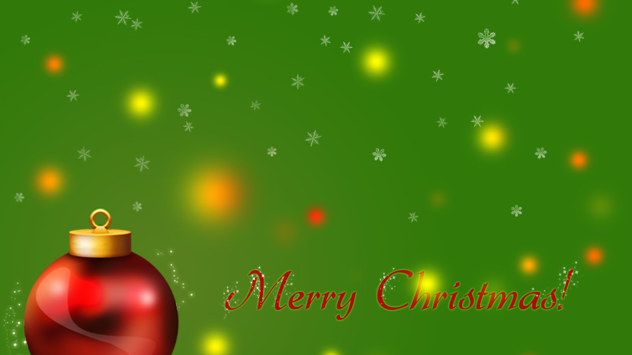 Красный ёлочный шар на зелёном фоне на рождество