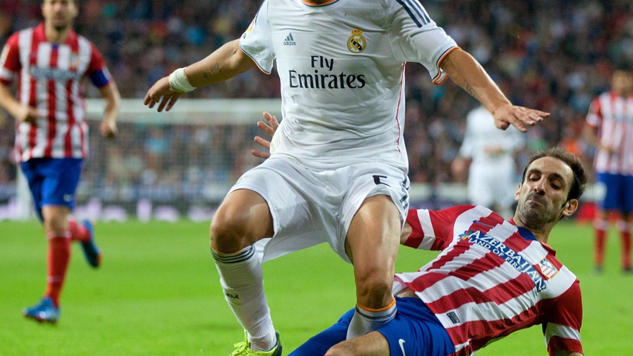 The football player of Real Madrid Fábio Coentrão is fighting for the ball
