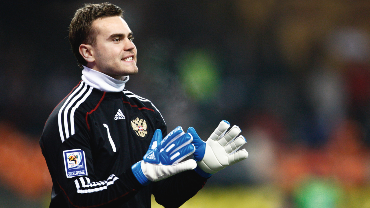 The player CSKA Moscow Igor Akinfeev is catching a ball