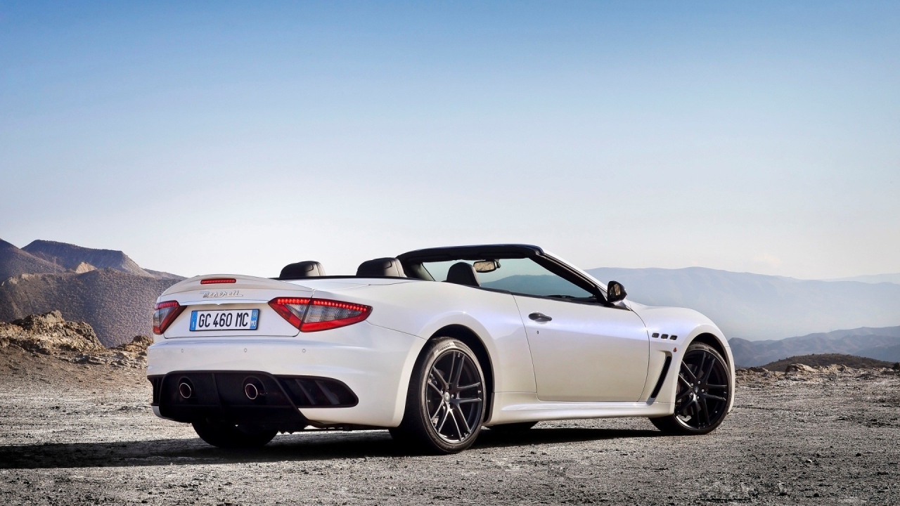 White convertible Maserati mountains in the background