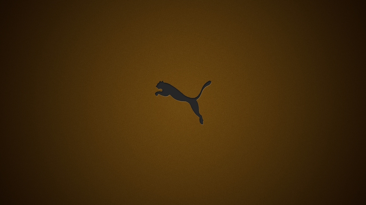Логотип фирмы Пума на коричневом фоне
