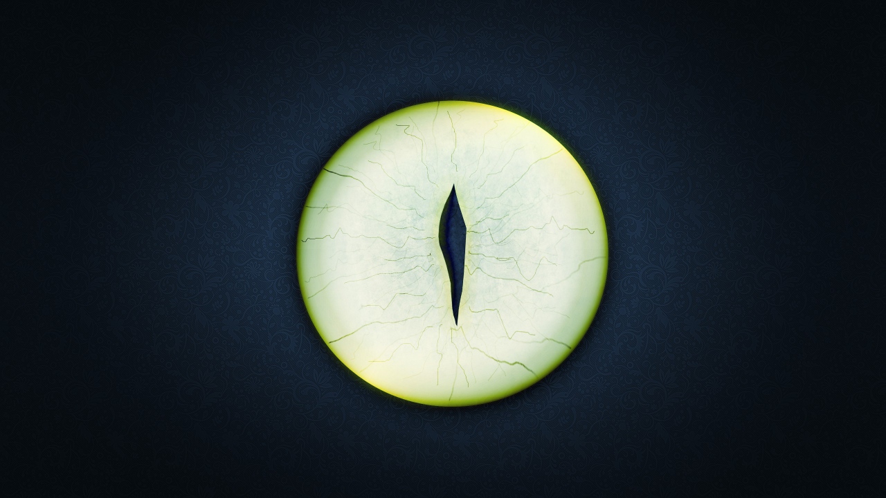 Круглый зеленый глаз на черном фоне