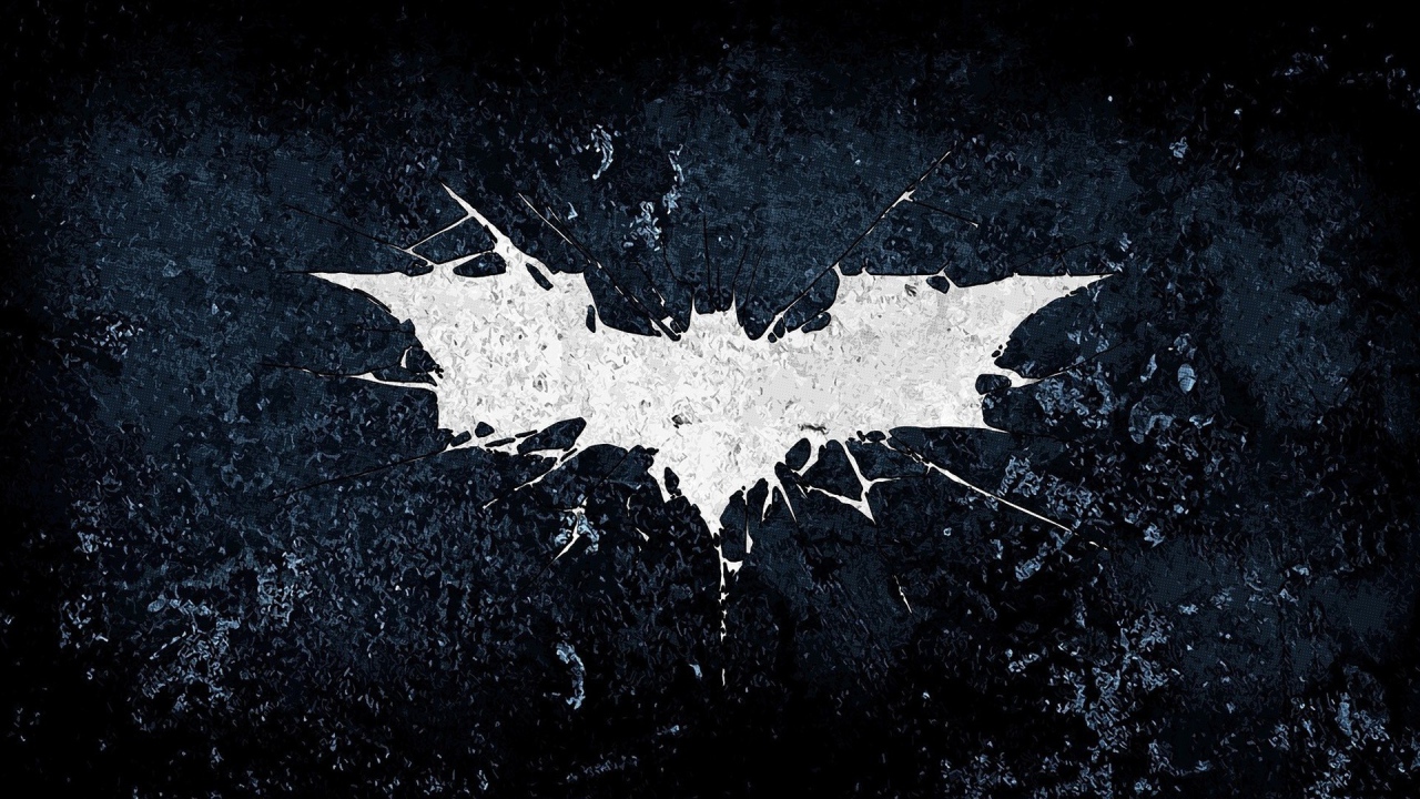 Белый символ летучей мыши на черном фоне