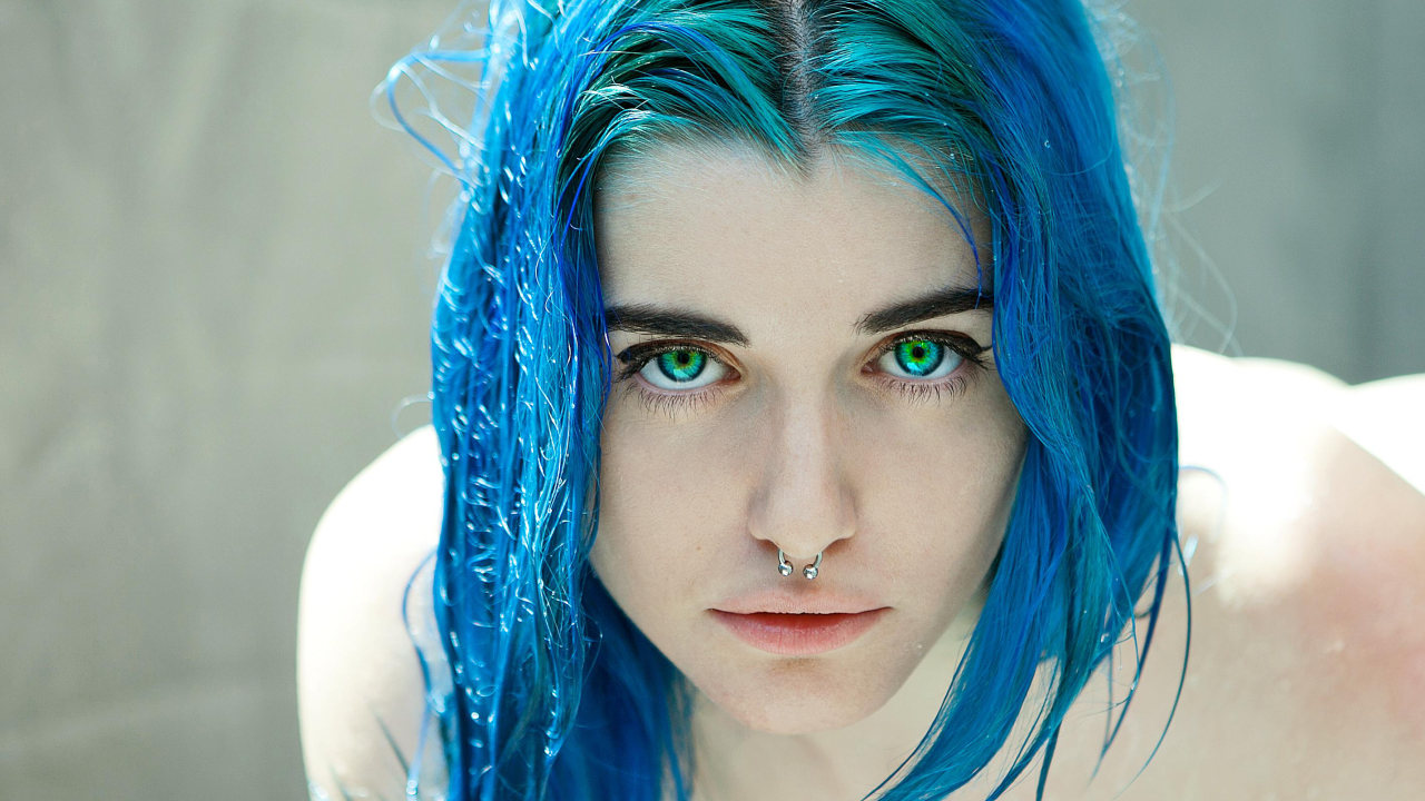 Зеленоглазая девушка с синими волосами и кольцом в носу