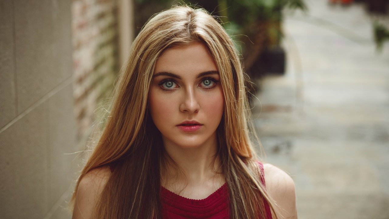 Блондинка с зелеными глазами идет по улице