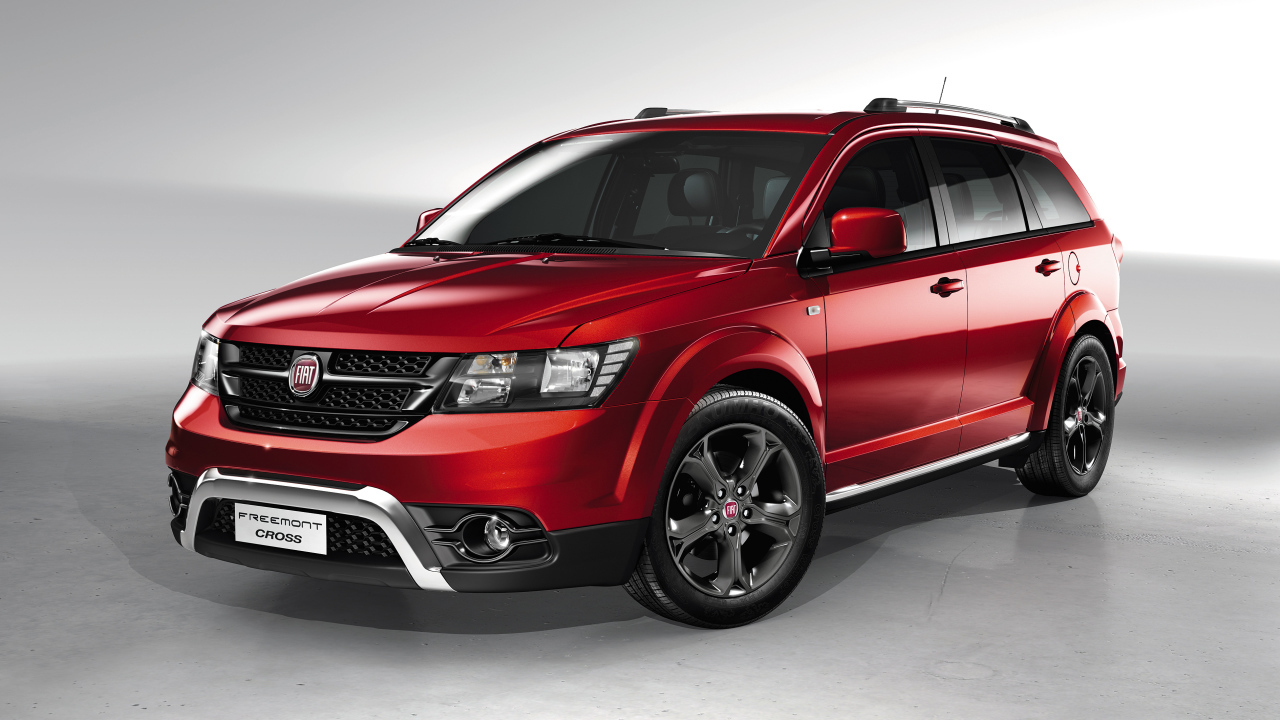 Красный автомобиль внедорожник Fiat Freemont Cross на сером фоне