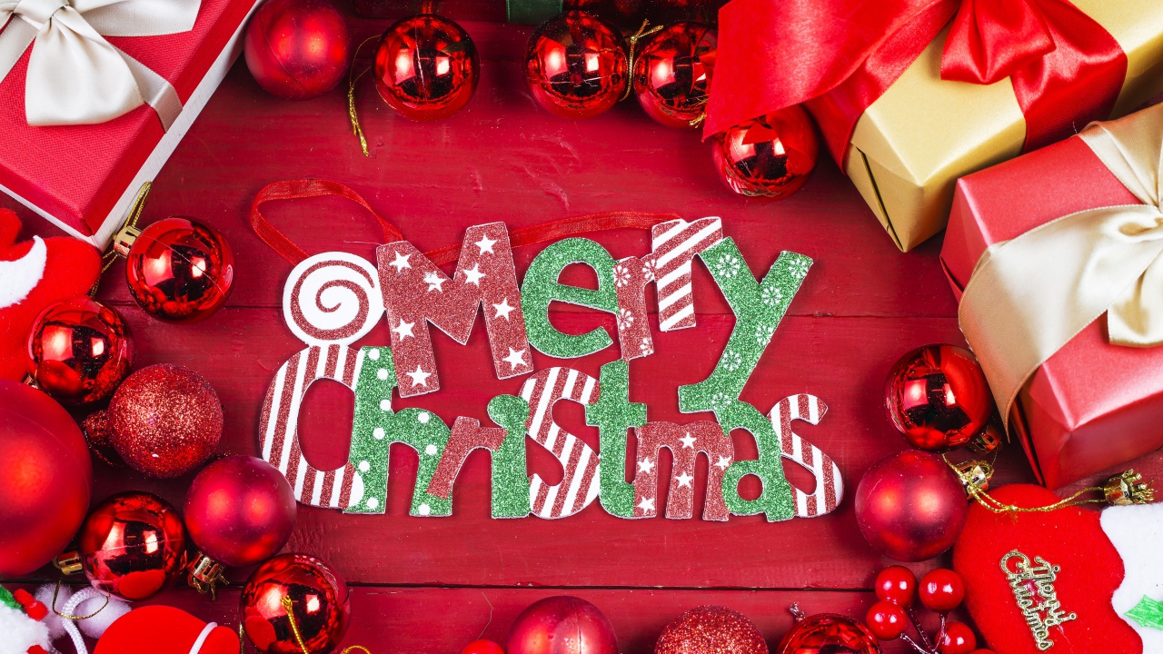 Merry Christmas holiday inscription on a red background with toys and gifts