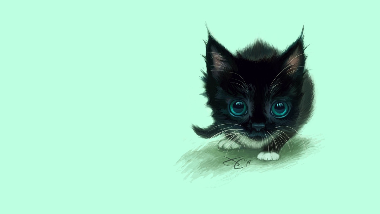 A small painted black kitten with big green eyes