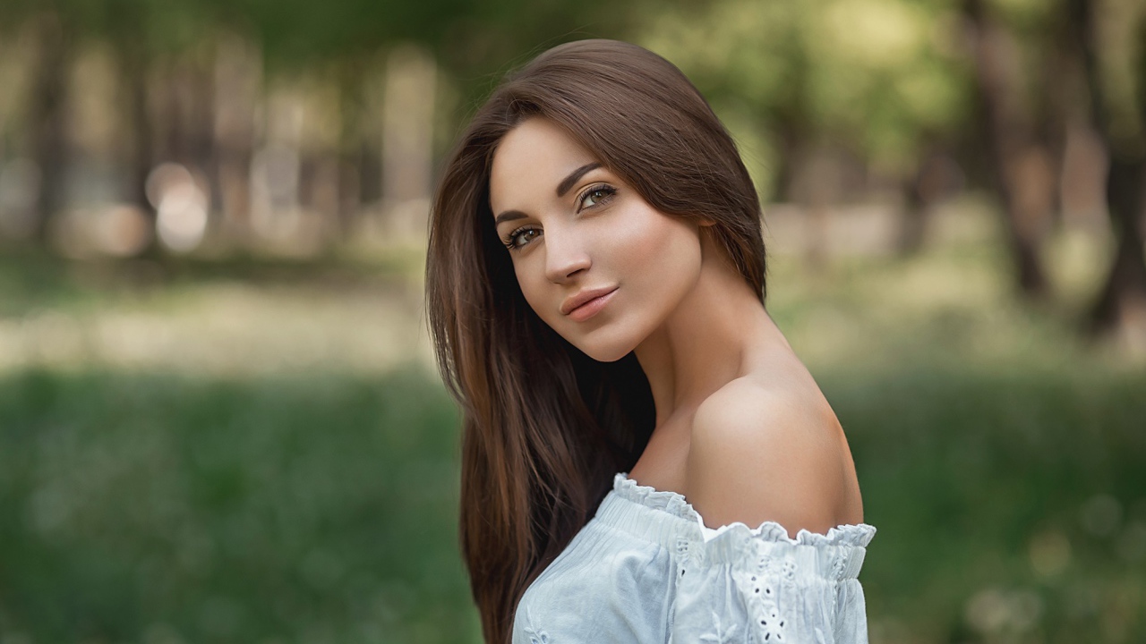 Молодая девушка с длинными волосами в белом 