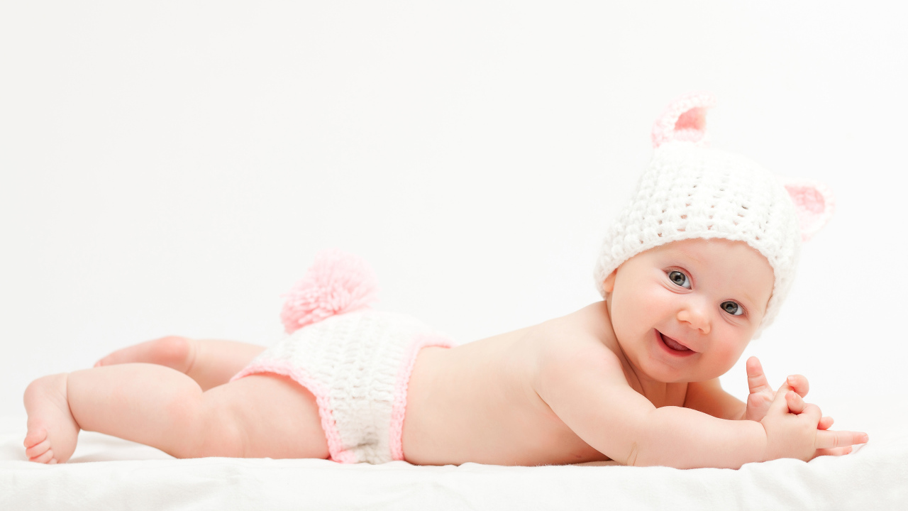 Милый улыбающийся младенец в вязаном костюме