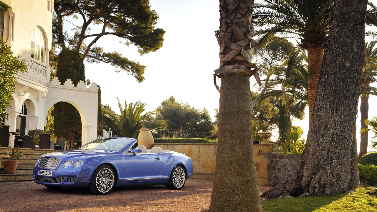 Автомобиль кабриолет Bentley Continental у дорого особняка 