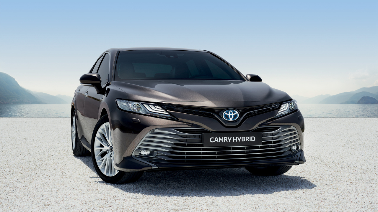 Автомобиль Toyota Camry Hybrid 2019 года стоит на песке