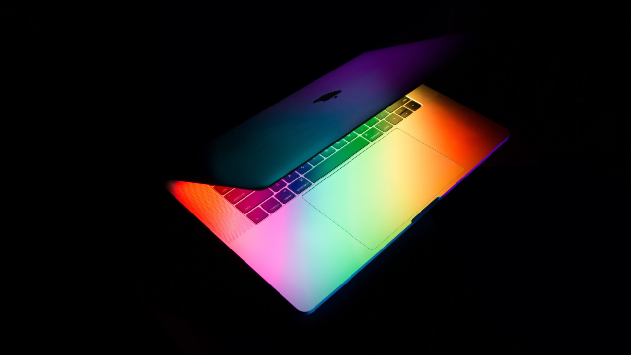 Открытый MacBook Apple  на черном фоне