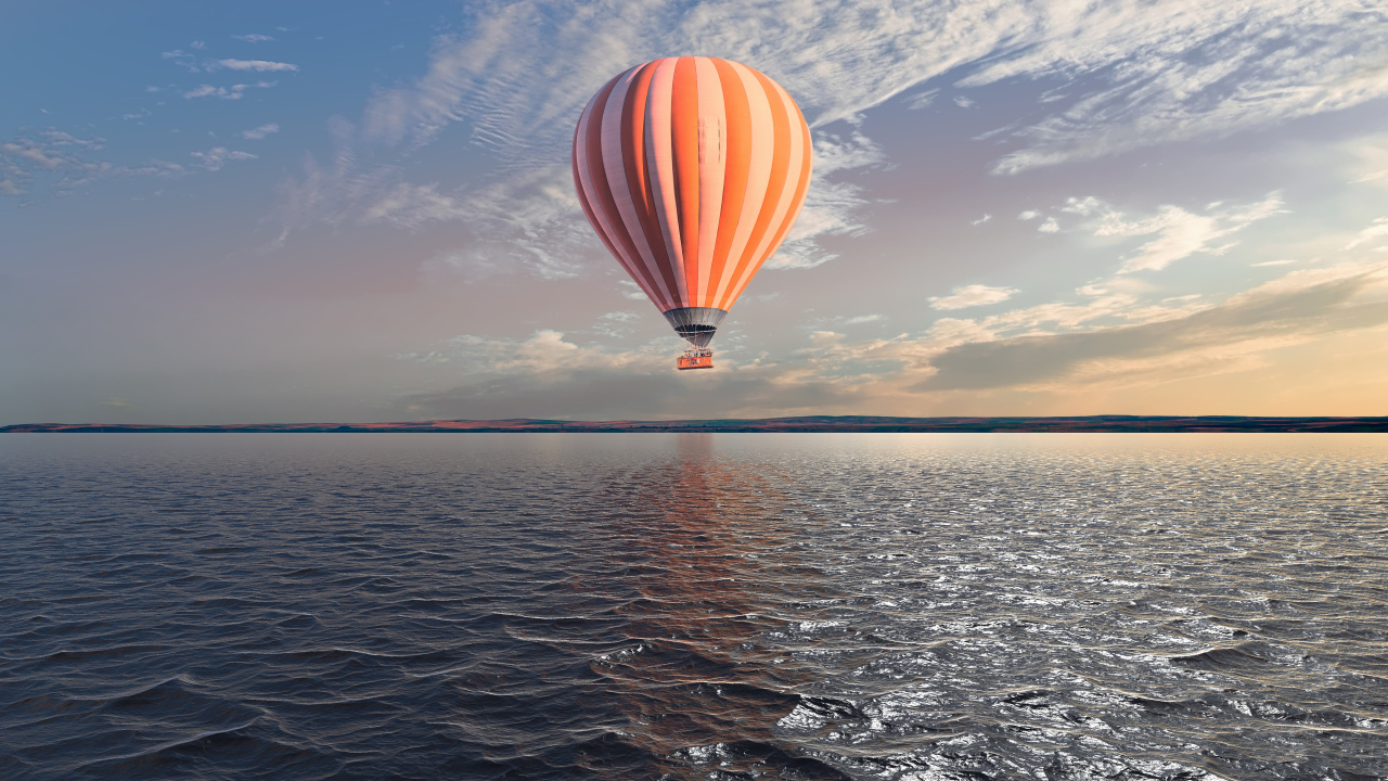 Big balloon over the sea in the blue sky