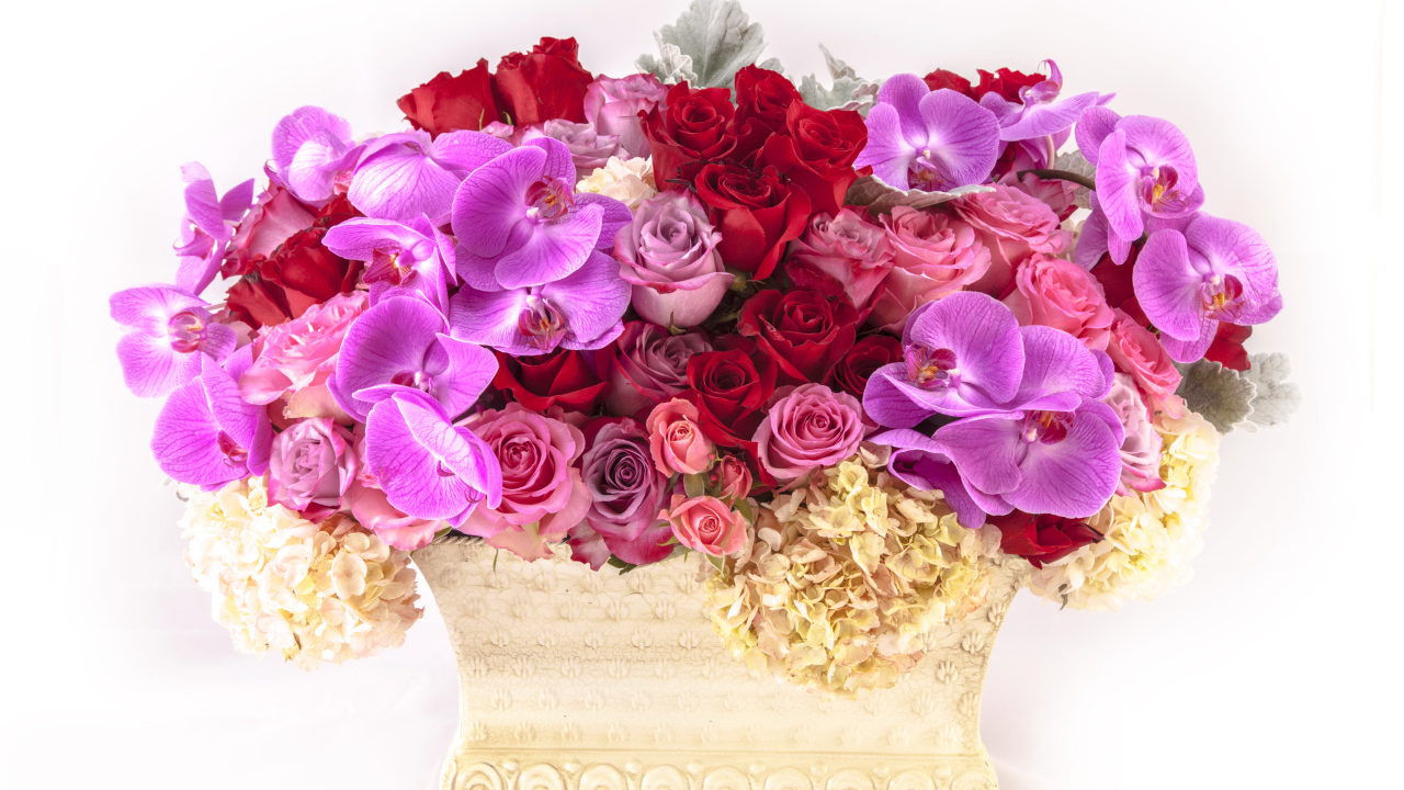 Basket with flowers of hydrangea, roses and orchids on a white background