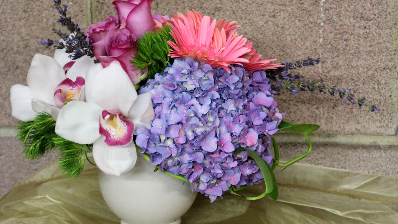 Красивый букет в белой вазе на фоне стены 