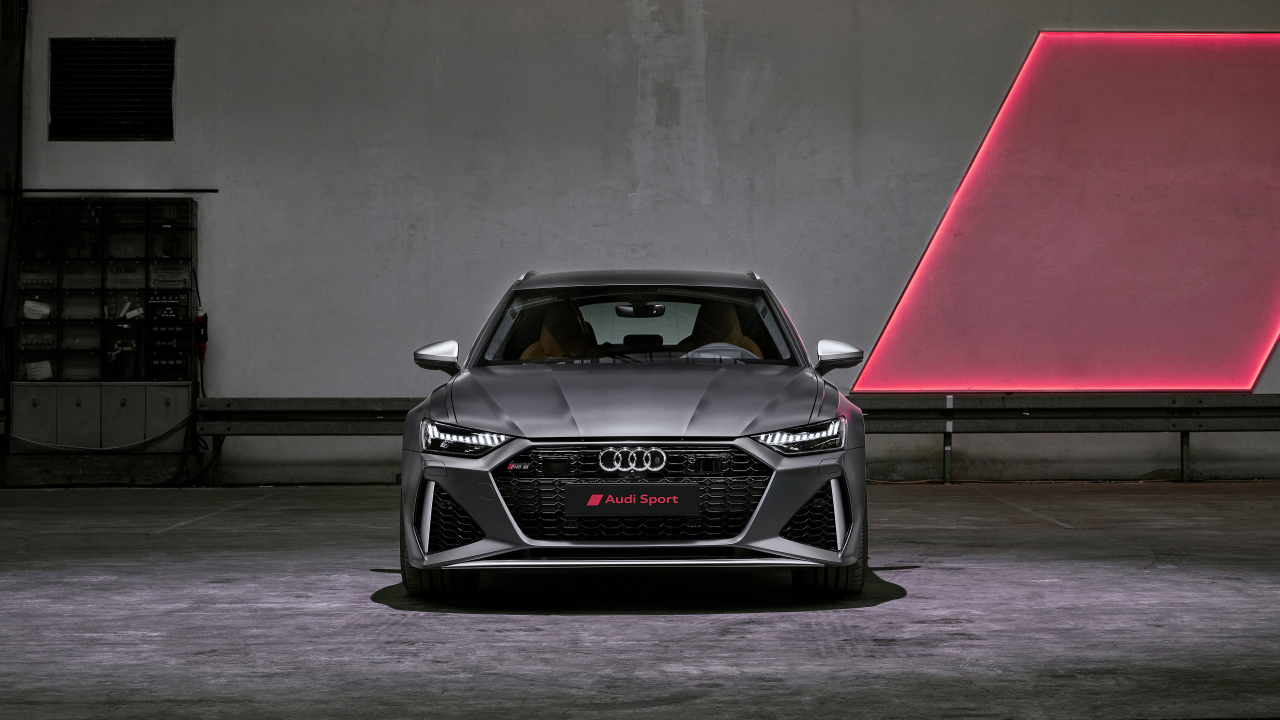 Silver car Audi RS6 Avant, 2020 on the background of the wall