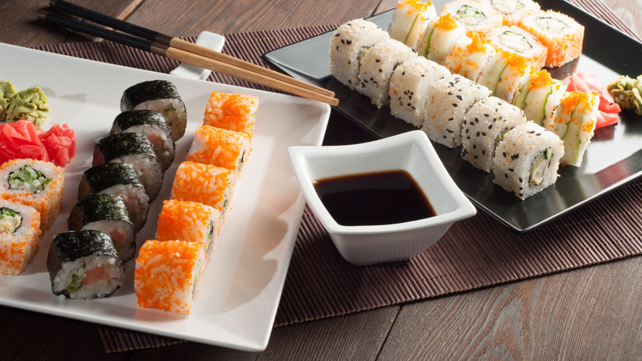 Суши на столе с соевым соусом и палочками