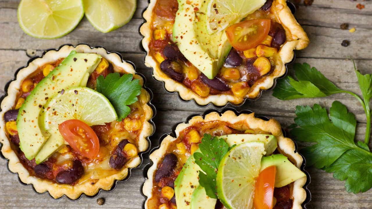 Tartlets with a dish of avocado and lime on the table