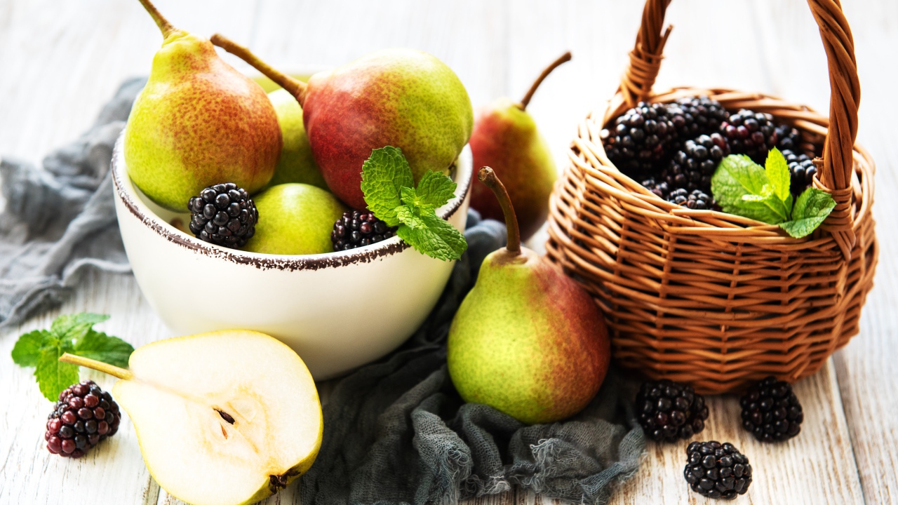 Спелые груши и ягоды ежевики на столе