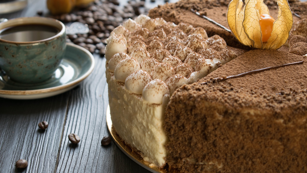 Вкусный торт с кремом и физалисом на столе с кофе